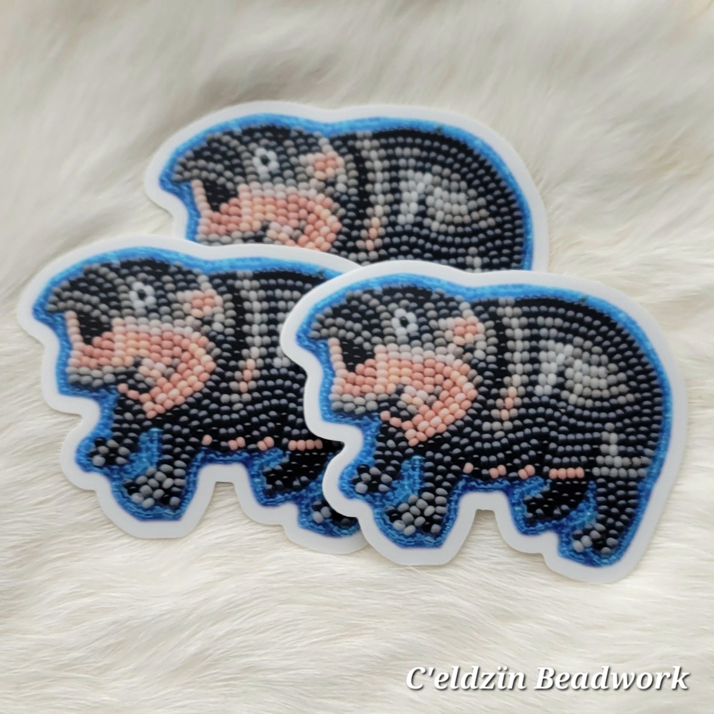 Stickers of the beaded baby hippo pin that I previously made. It is a baby hippo with a surprised look, and it's outlined with a pretty medium blue.
